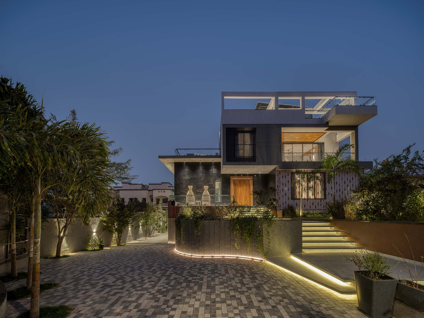 Anagh Residence, a completed villa project by Pathway Design Studio, illuminated at dusk